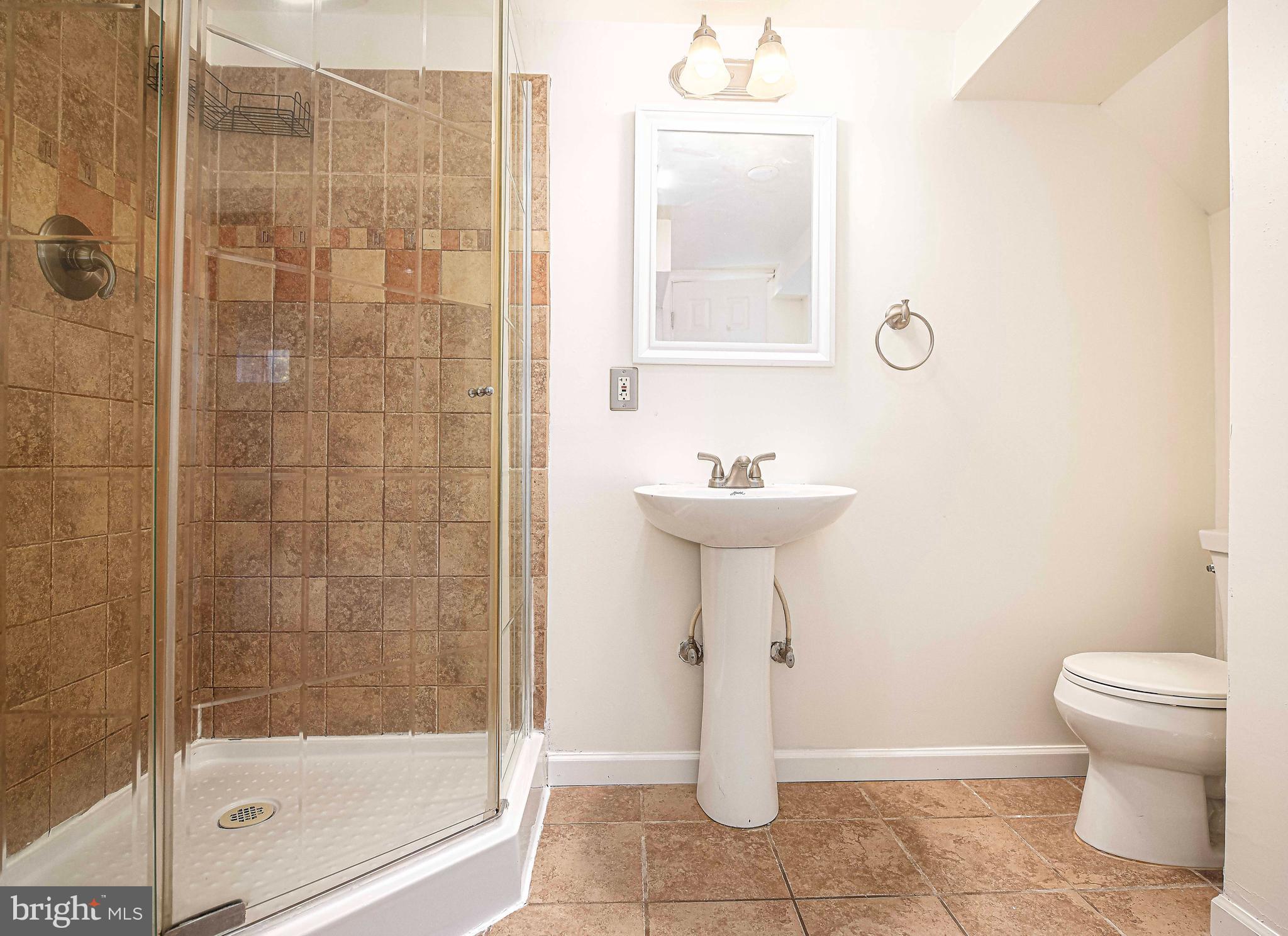 967 Radcliffe Road Baltimore, MD 21204 - Photo 20 of 26 a bathroom with a sink a toilet and shower