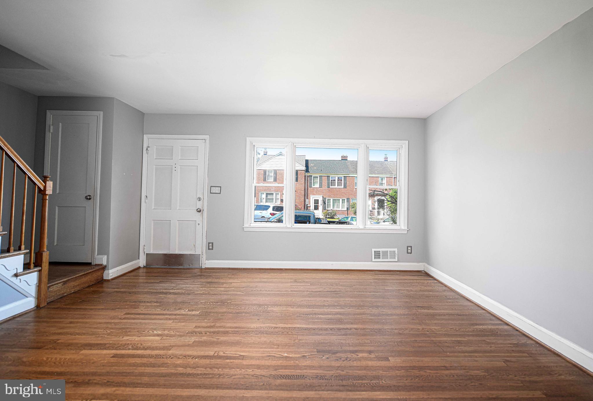 967 Radcliffe Road Baltimore, MD 21204 - Photo 5 of 26 a view of an empty room with window and wooden floor