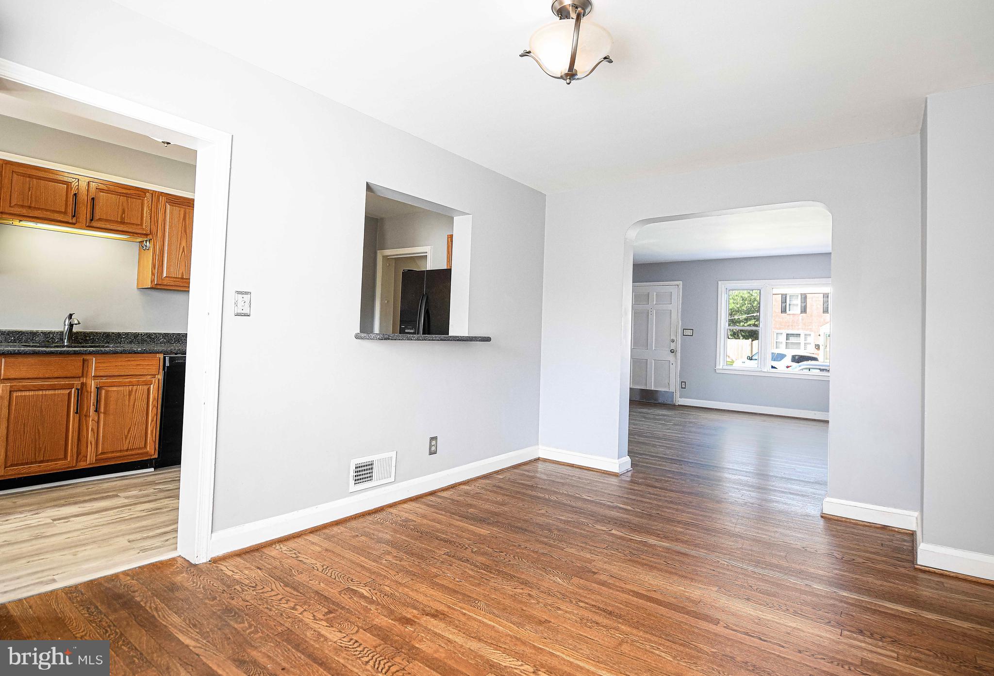 967 Radcliffe Road Baltimore, MD 21204 - Photo 8 of 26 a view of a hallway with wooden floor and a bathroom