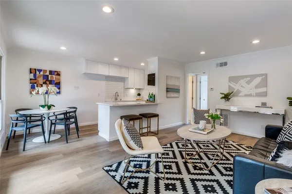 a kitchen with a dining table and chairs