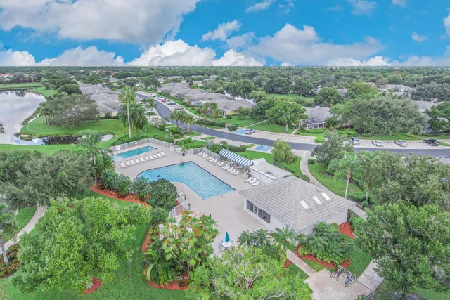 an aerial view of residential houses with outdoor space and street view
