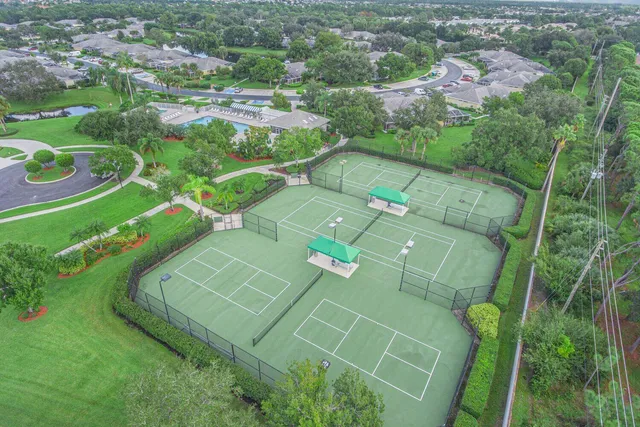 an aerial view of a residential houses with outdoor space and street view