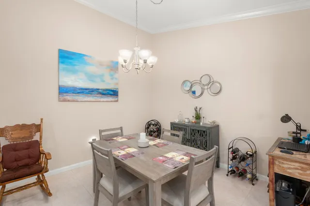 a view of a workspace with furniture and a chandelier