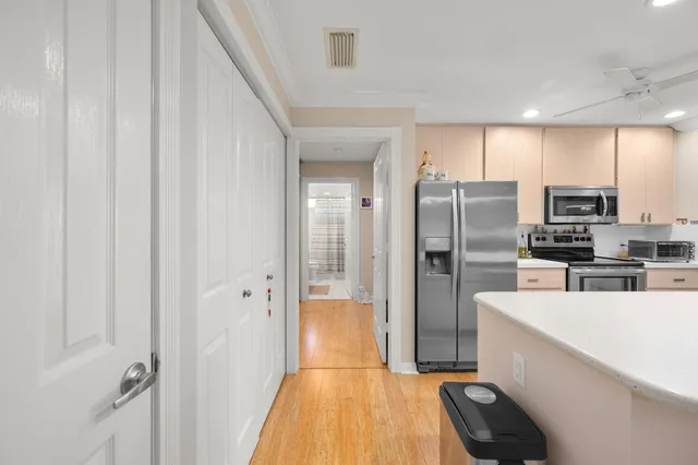 a kitchen with stainless steel appliances a refrigerator and a sink