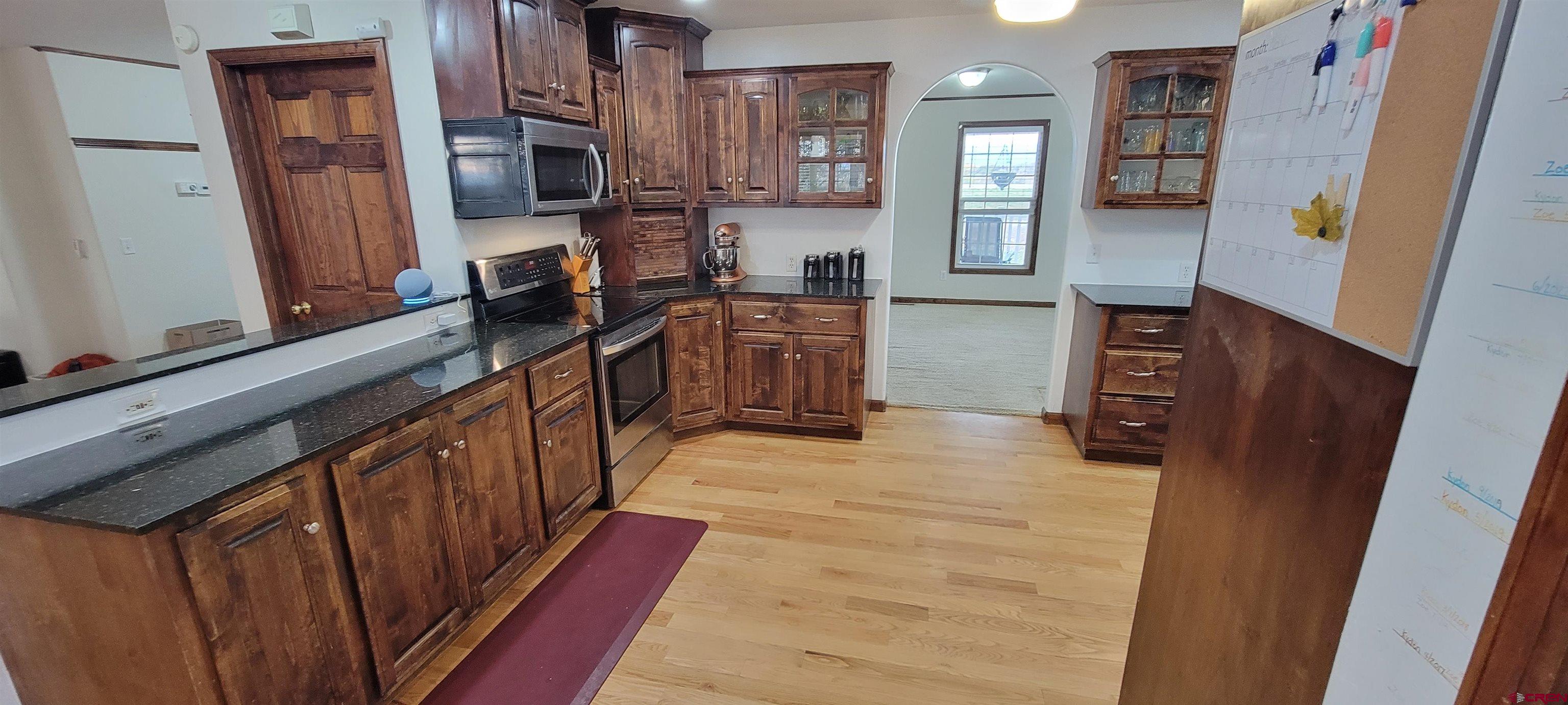 18424 F Road Delta, CO 81416 - Photo 9 of 35 a kitchen with stainless steel appliances a refrigerator and a stove