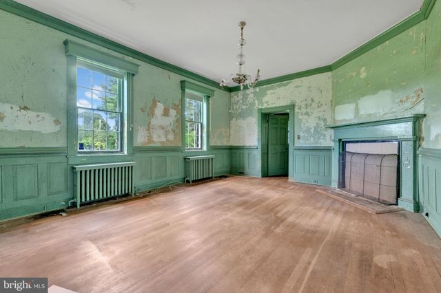 a view of a room with a large window and chandelier