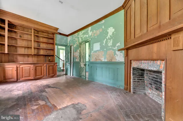 a view of a room with wooden walls and a window