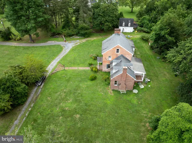 an aerial view of a house with a garden and trees