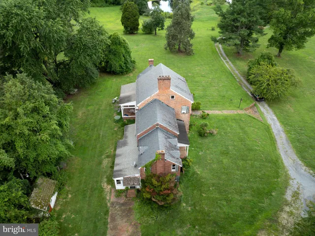 an aerial view of a house with a yard