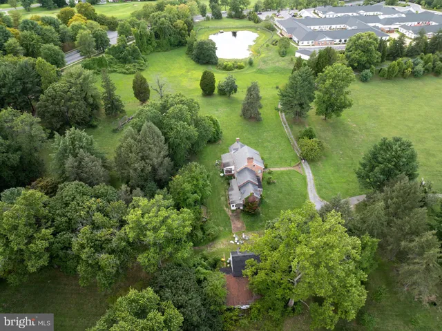 a backyard of a house with a yard and outdoor seating