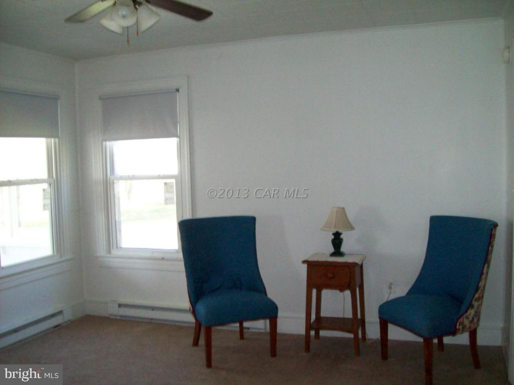 23421 Deal Island Road Deal Island, MD 21821 - Photo 8 of 14 a room with a chair and a window