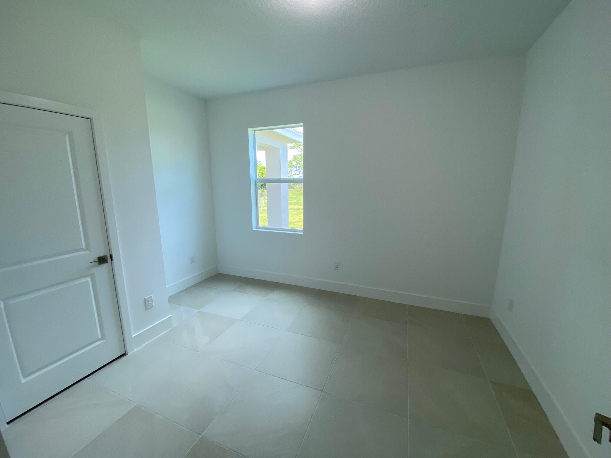 7011 Southeast Park Trace Drive Stuart, FL 34997 - Photo 11 of 19 an empty room with windows