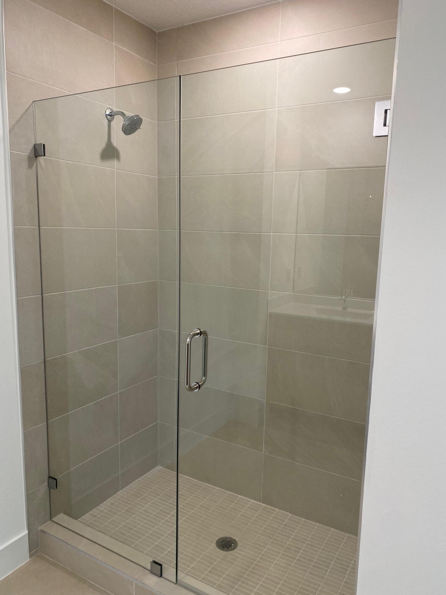 7011 Southeast Park Trace Drive Stuart, FL 34997 - Photo 13 of 19 a bathroom with a shower