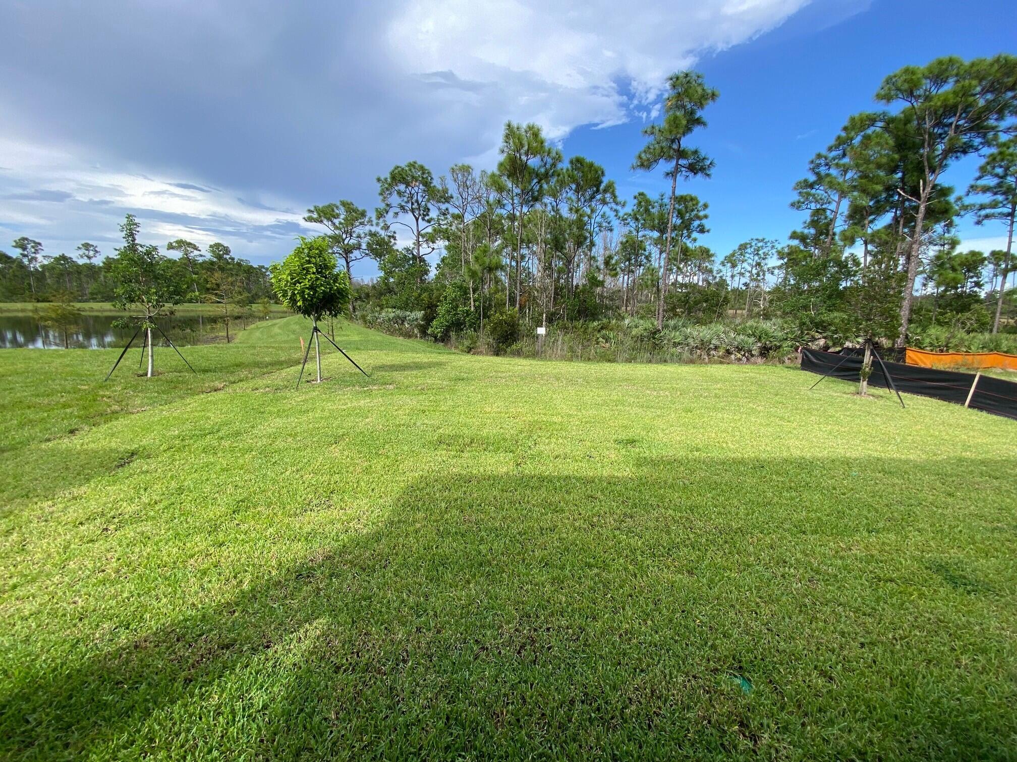 7011 Southeast Park Trace Drive Stuart, FL 34997 - Photo 19 of 19 a view of a field with a tree