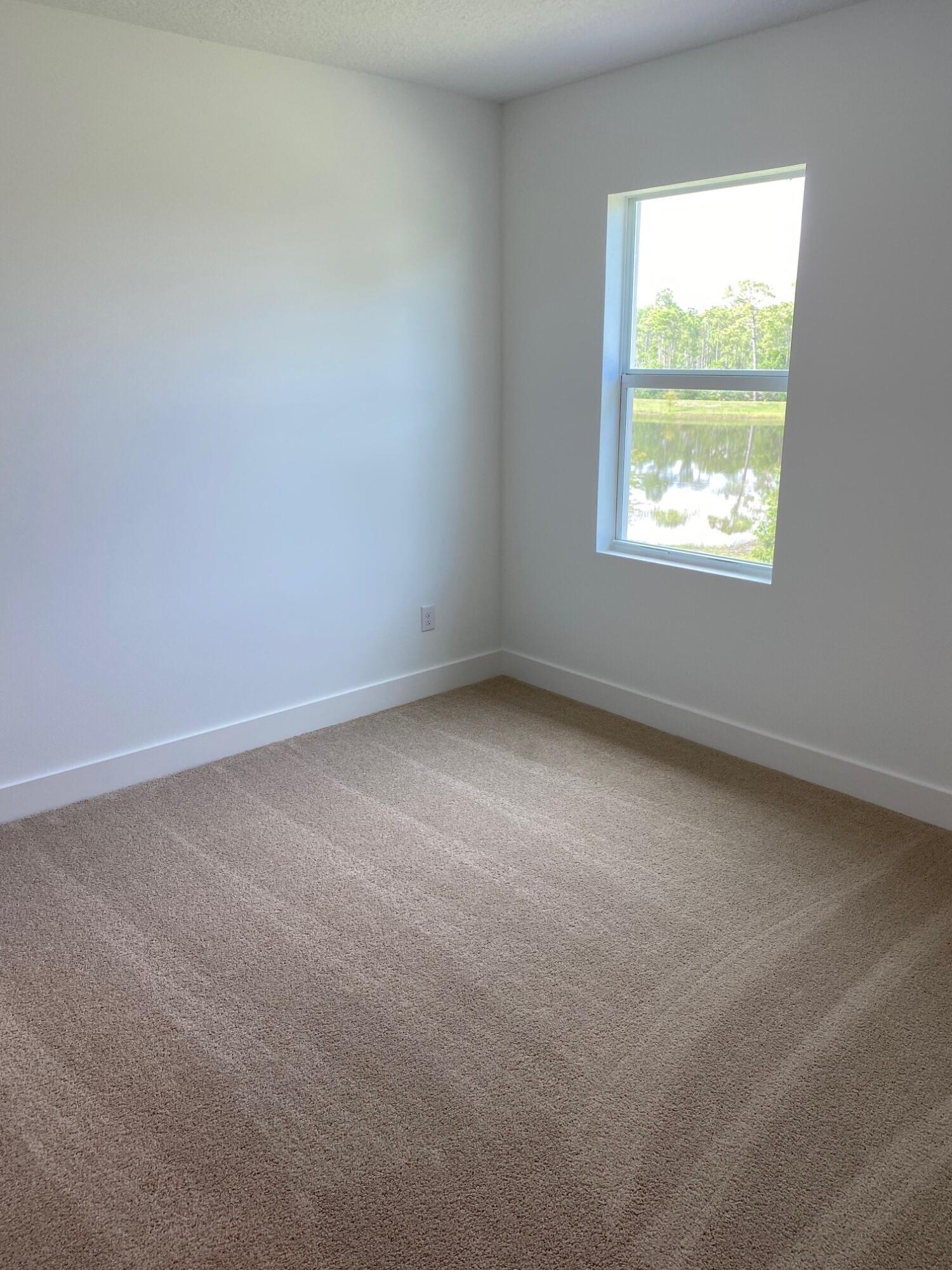 7011 Southeast Park Trace Drive Stuart, FL 34997 - Photo 9 of 19 an empty room with a window