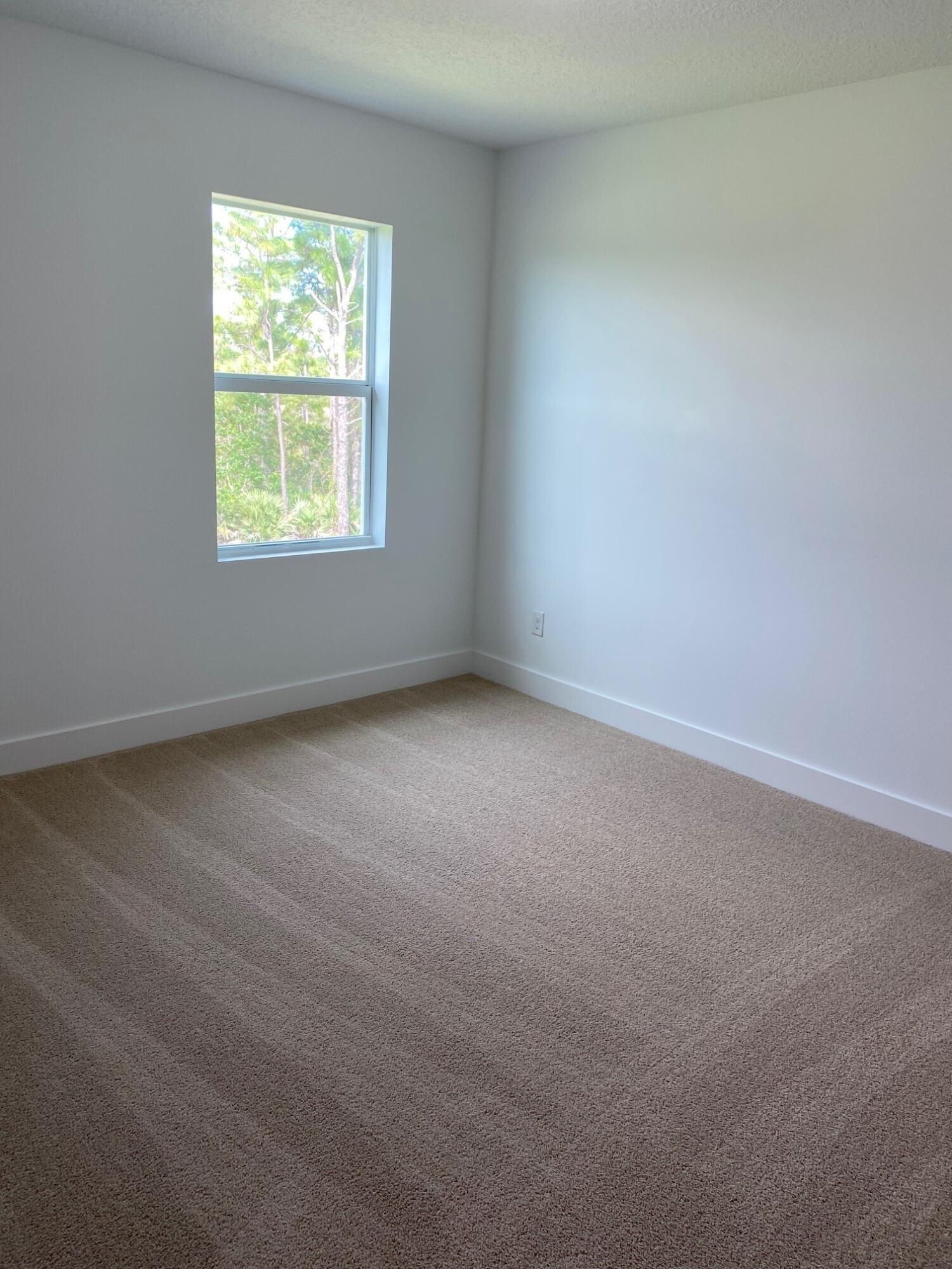 7011 Southeast Park Trace Drive Stuart, FL 34997 - Photo 10 of 19 an empty room with a window