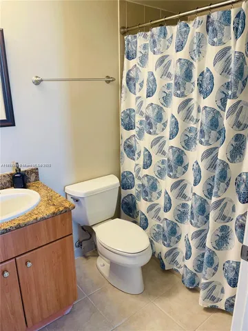 a bathroom with a granite countertop sink a mirror and a bathtub
