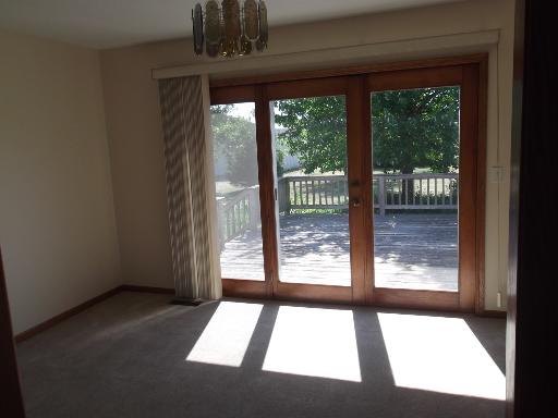 1279 Locust Road Lee, IL 60530 - Photo 12 of 14 a view of an empty room with wooden floor and a floor to ceiling window
