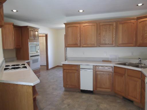 1279 Locust Road Lee, IL 60530 - Photo 10 of 14 a kitchen with stainless steel appliances granite countertop a stove a sink and a refrigerator