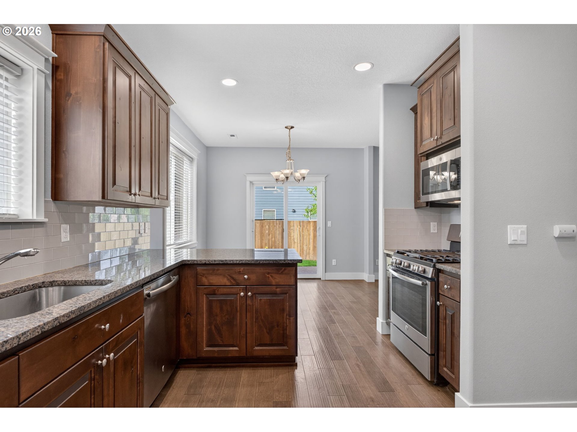 410 Rentfro Way Newberg, OR 97132 - Photo 11 of 39 a kitchen with stainless steel appliances granite countertop a sink stove and refrigerator