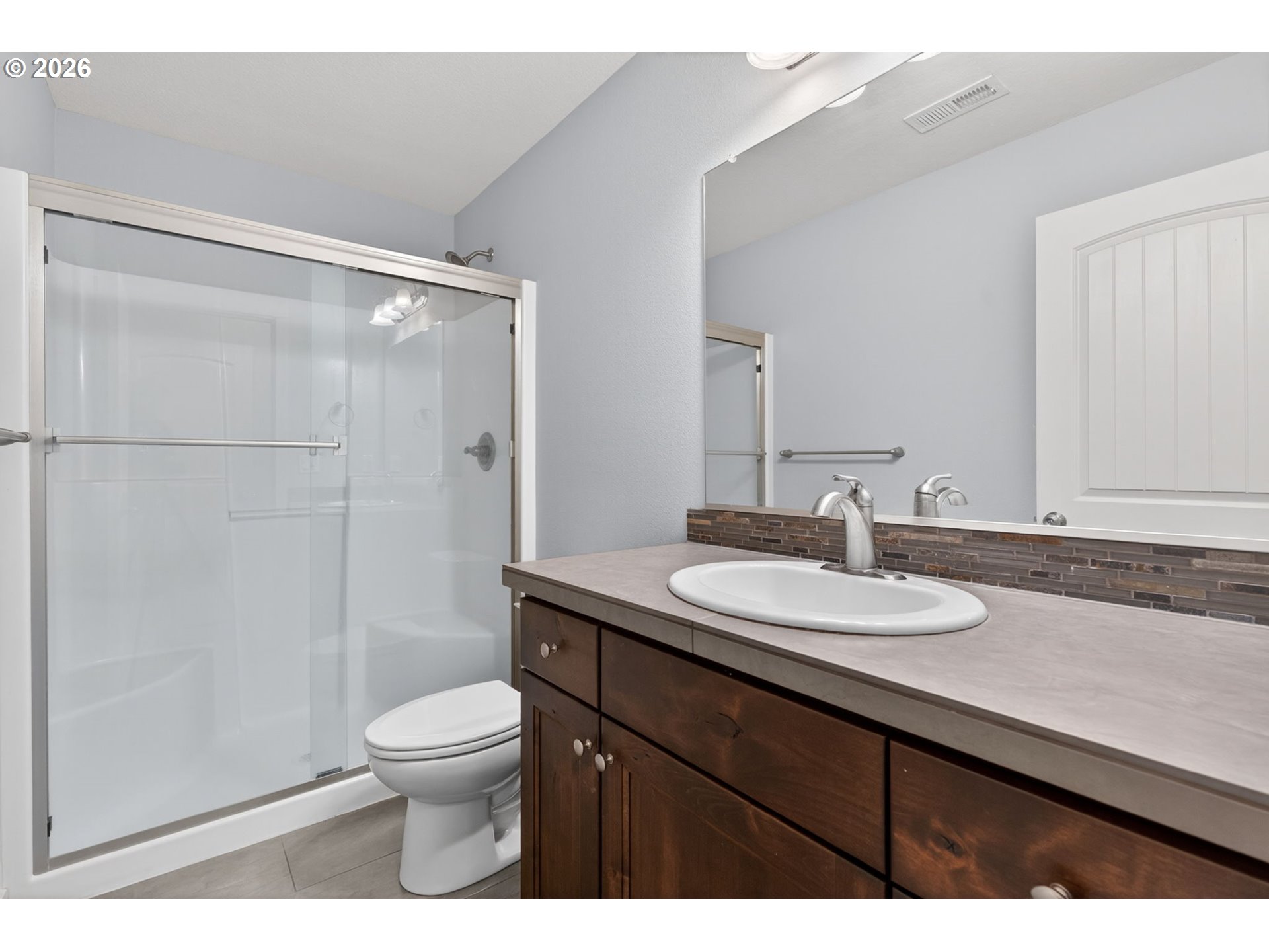 410 Rentfro Way Newberg, OR 97132 - Photo 15 of 39 a bathroom with a granite countertop sink toilet a mirror and shower