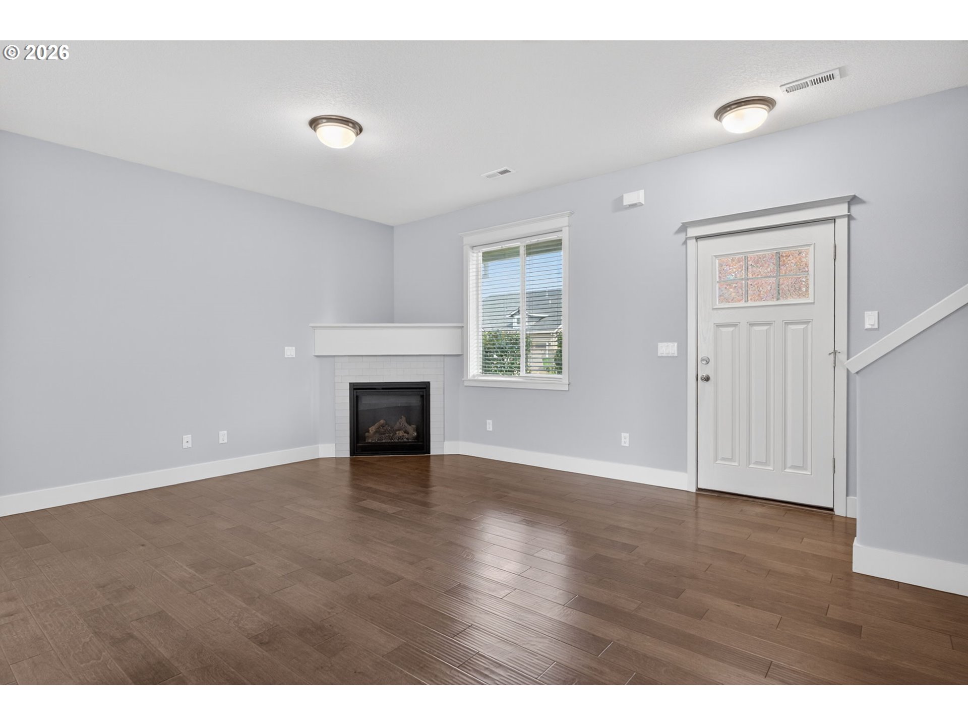410 Rentfro Way Newberg, OR 97132 - Photo 4 of 39 a view of an empty room with wooden floor and a window