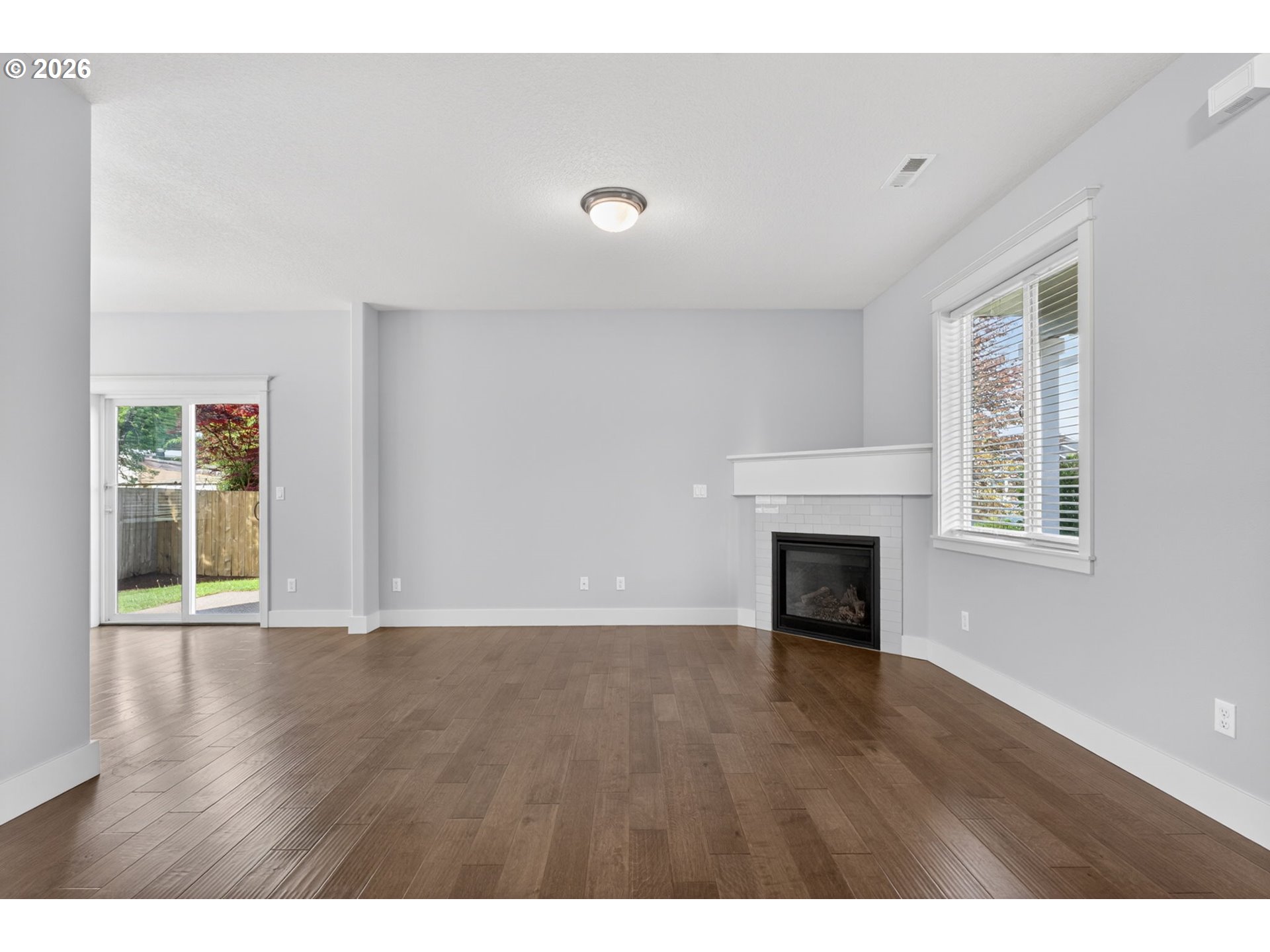 410 Rentfro Way Newberg, OR 97132 - Photo 5 of 39 a view of an empty room with wooden floor and a window