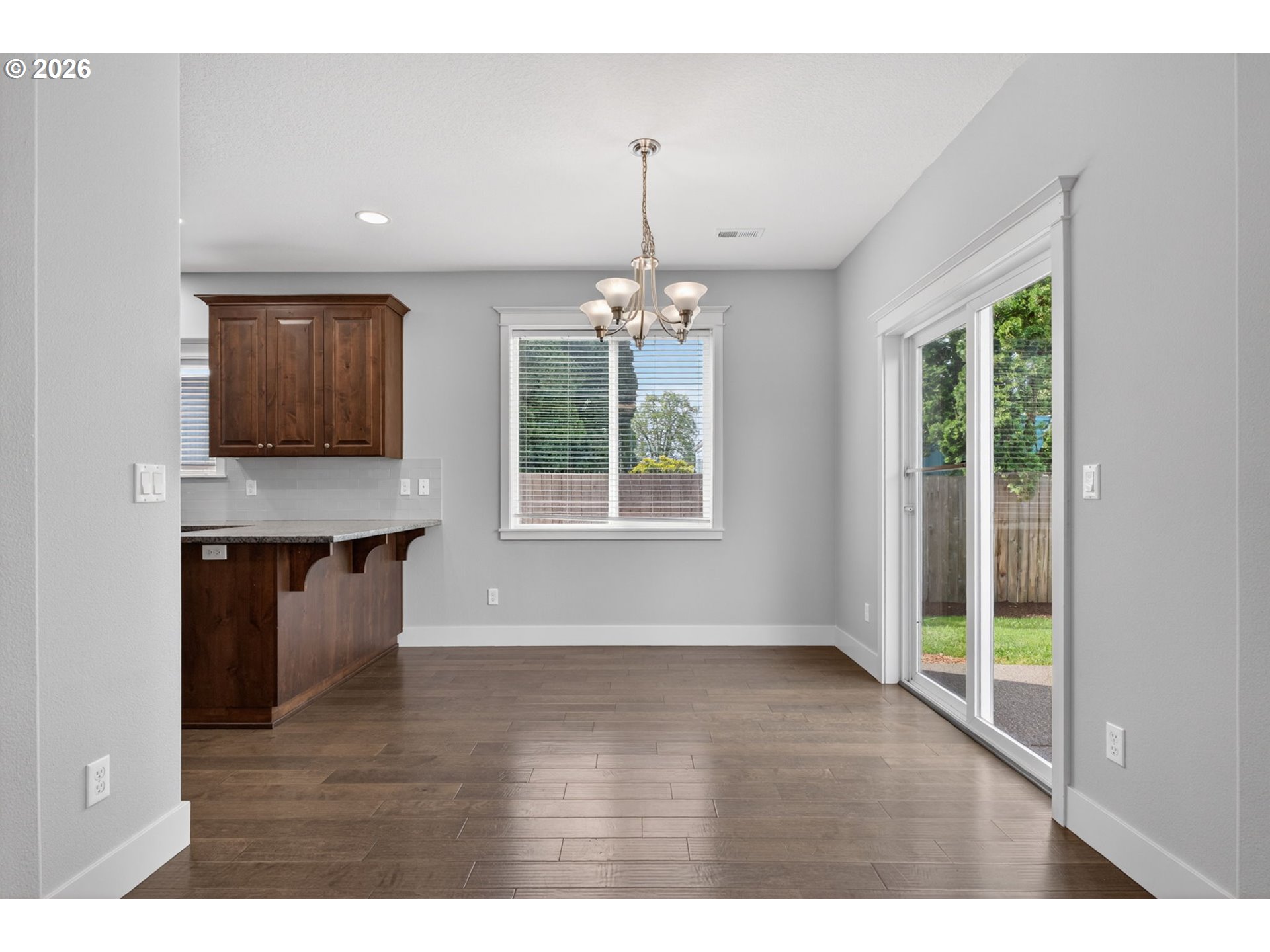 410 Rentfro Way Newberg, OR 97132 - Photo 6 of 39 a view of an empty room with a window and wooden floor