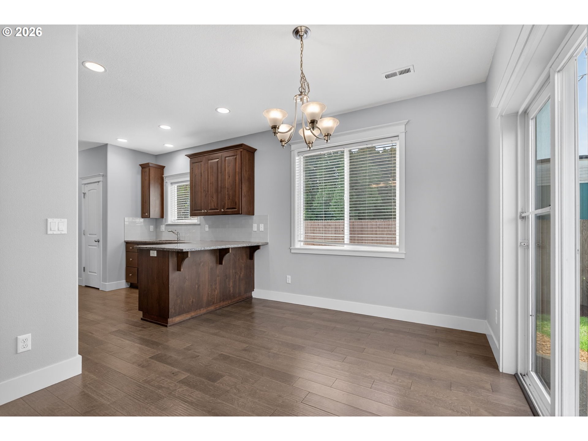 410 Rentfro Way Newberg, OR 97132 - Photo 7 of 39 a view of a kitchen with granite countertop cabinets and wooden floor
