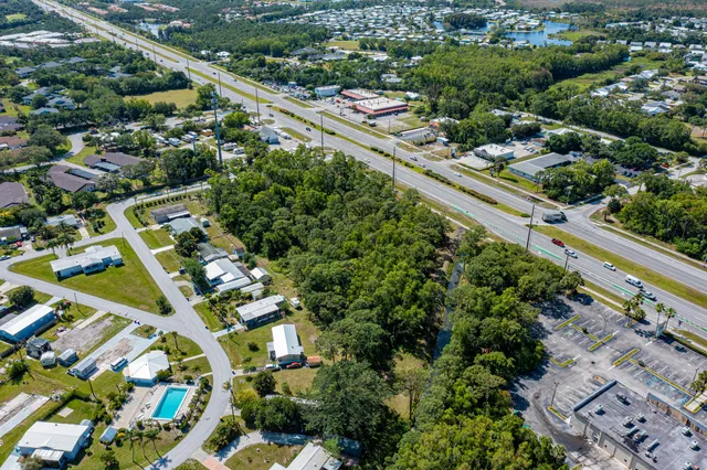 an aerial view of residential houses with yard