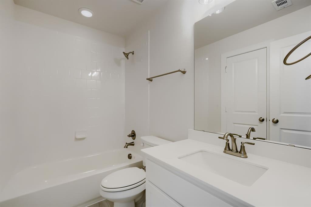828 Stone Grv Road Lavon, TX 75166 - Photo 22 of 27 Bathroom featuring a vanity with an integrated sink, brushed nickel faucet, and a large mirror