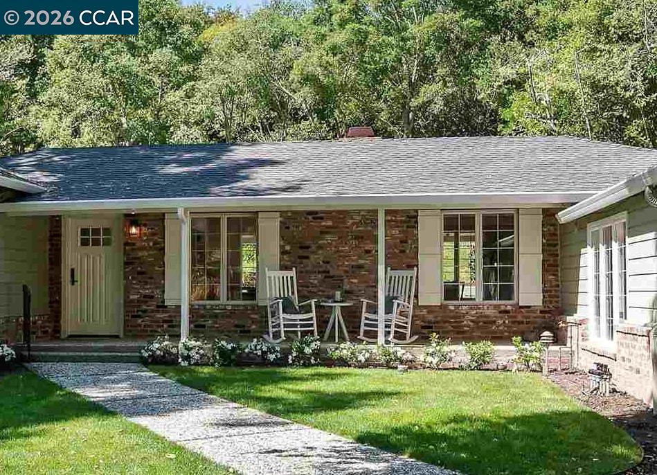 120 Las Vegas Road Orinda, CA 94563 - Photo 1 of 23 a front view of a house with a yard table and chairs