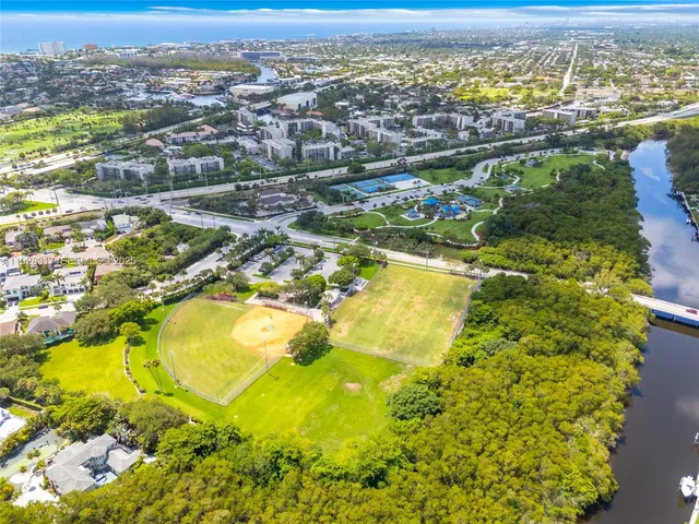 a view of a house with a yard and potted plants