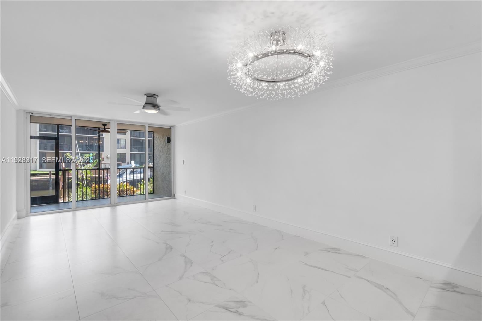 12 Royal Palm Way, Unit 103 Boca Raton, FL 33432 - Photo 6 of 29 an empty room with wooden floor and windows