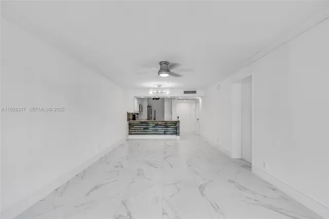 a view of a kitchen with a sink and a chandelier fan