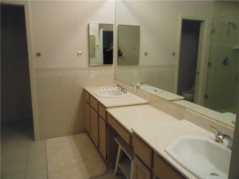 4716 Monument Valley Road Las Vegas, NV 89129 - Photo 15 of 31 Property Photo. Enjoy his and her sinks and make-up area at master bath.