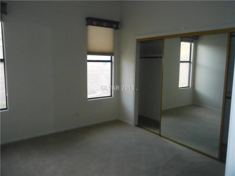 4716 Monument Valley Road Las Vegas, NV 89129 - Photo 18 of 31 Property Photo. Bed 4 with ceiling fan and mirrored bypass doors.
