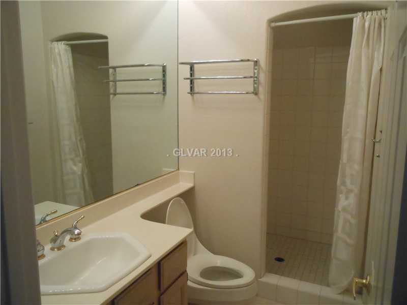 4716 Monument Valley Road Las Vegas, NV 89129 - Photo 22 of 31 Property Photo. Bath 3 with large separate shower, banjo countertop with extended mirror.