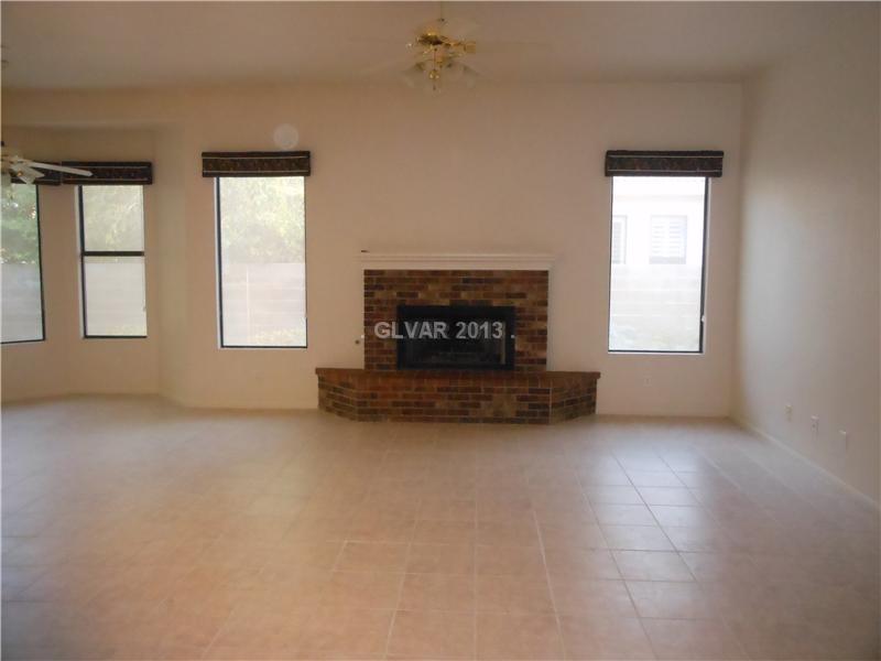 4716 Monument Valley Road Las Vegas, NV 89129 - Photo 6 of 31 Property Photo. Large tiled family room with fireplace. Nook off to the left.