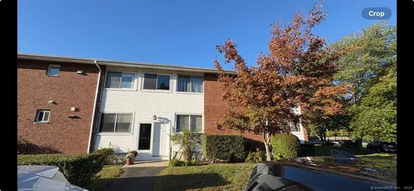 a view of a white house with a yard