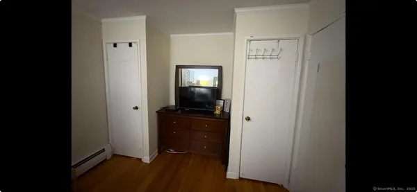 a view of a room with wooden floor and air conditioner