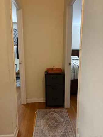 a living room with table chairs and wooden floor