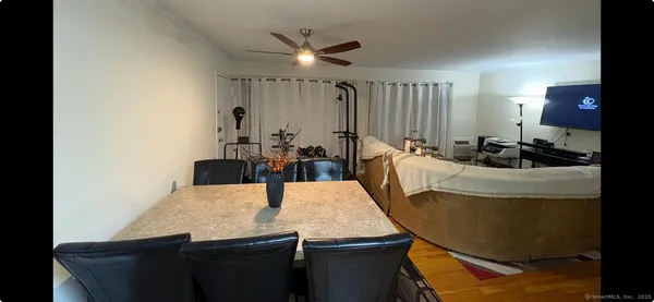 a bedroom with a bed and a flat tv screen on a dresser