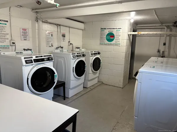 a bathroom with a granite countertop shower a sink and wooden floor