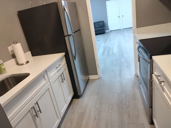 a view of a kitchen from a hallway