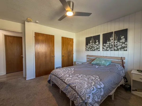 a bedroom with a bed a desk and chair