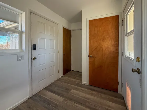 a spacious bedroom with a bed and wooden floor