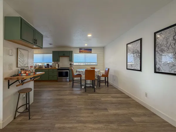 a kitchen with sink a microwave and cabinets