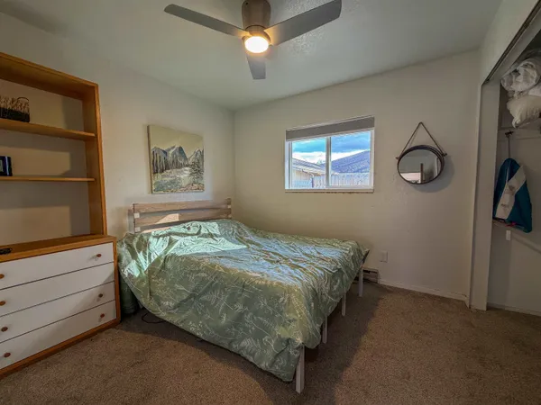 a bed sitting in a bedroom next to a window