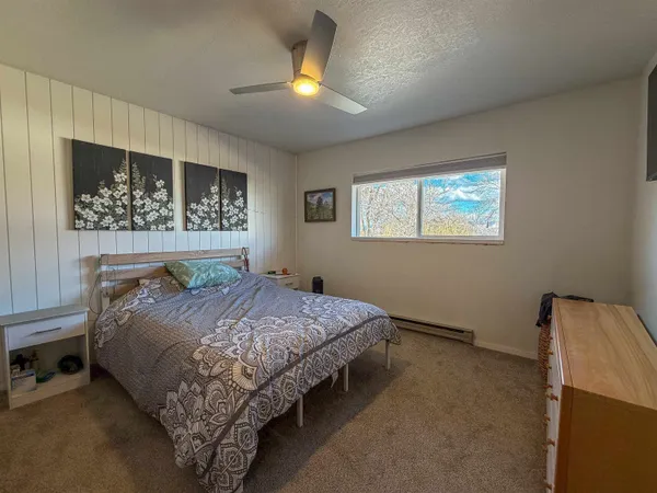 a bedroom with a large bed and a chandelier